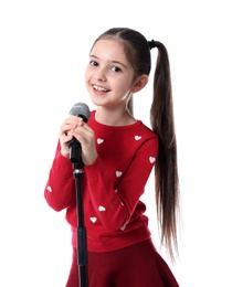 Little girl singing into microphone on white background