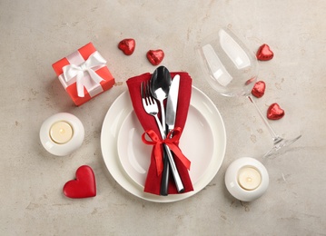 Photo of Beautiful table setting for Valentine's Day dinner on light background, flat lay