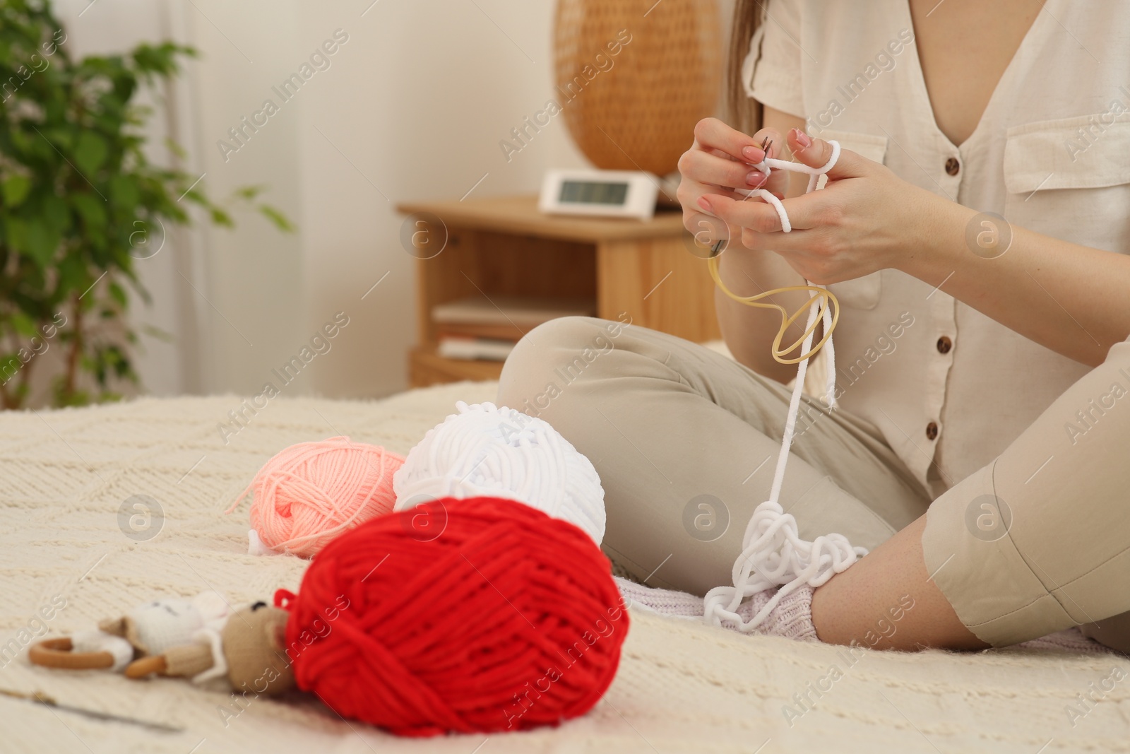 Photo of Woman knitting with needles at home, closeup. Handicraft hobby