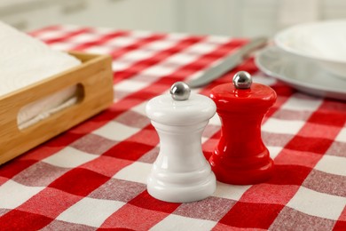 Photo of Ceramic salt and pepper mills on kitchen table. Space for text