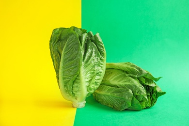 Photo of Fresh ripe cos lettuce on color background