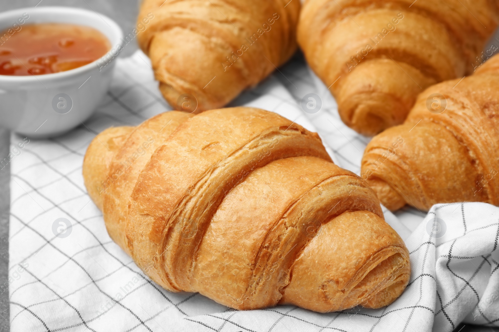 Photo of Tasty croissants with jam, closeup