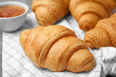 Photo of Tasty croissants with jam, closeup