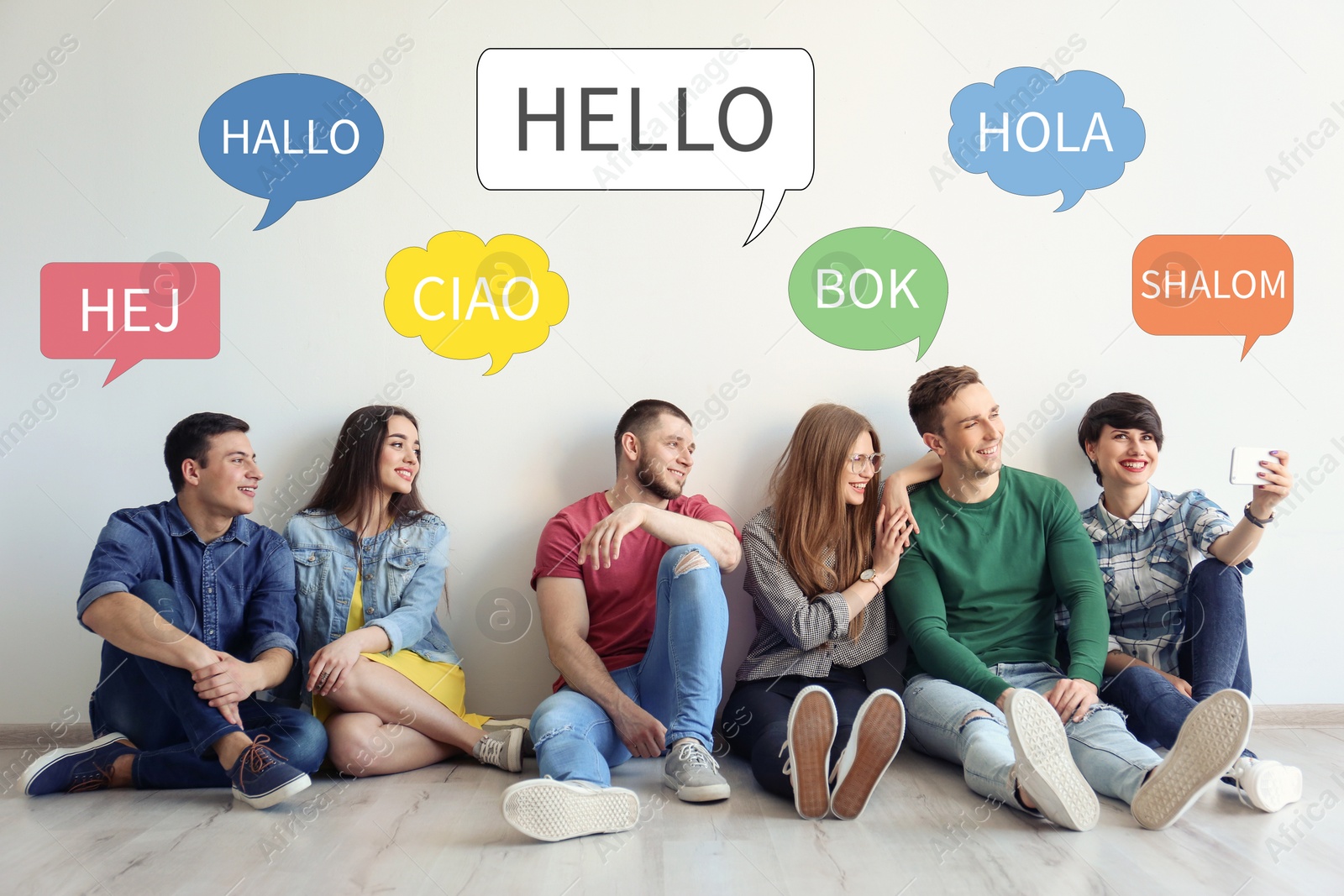 Image of Happy people sitting near light wall and illustration of speech bubbles with word Hello written in different languages