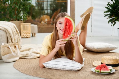 Photo of Beautiful teenage girl with slice of watermelon at home
