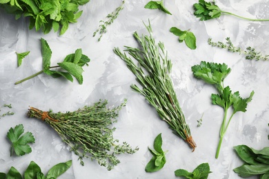 Photo of Flat lay composition with fresh green herbs on grey background