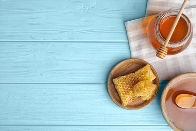 Photo of Flat lay composition with delicious honey on blue wooden table. Space for text