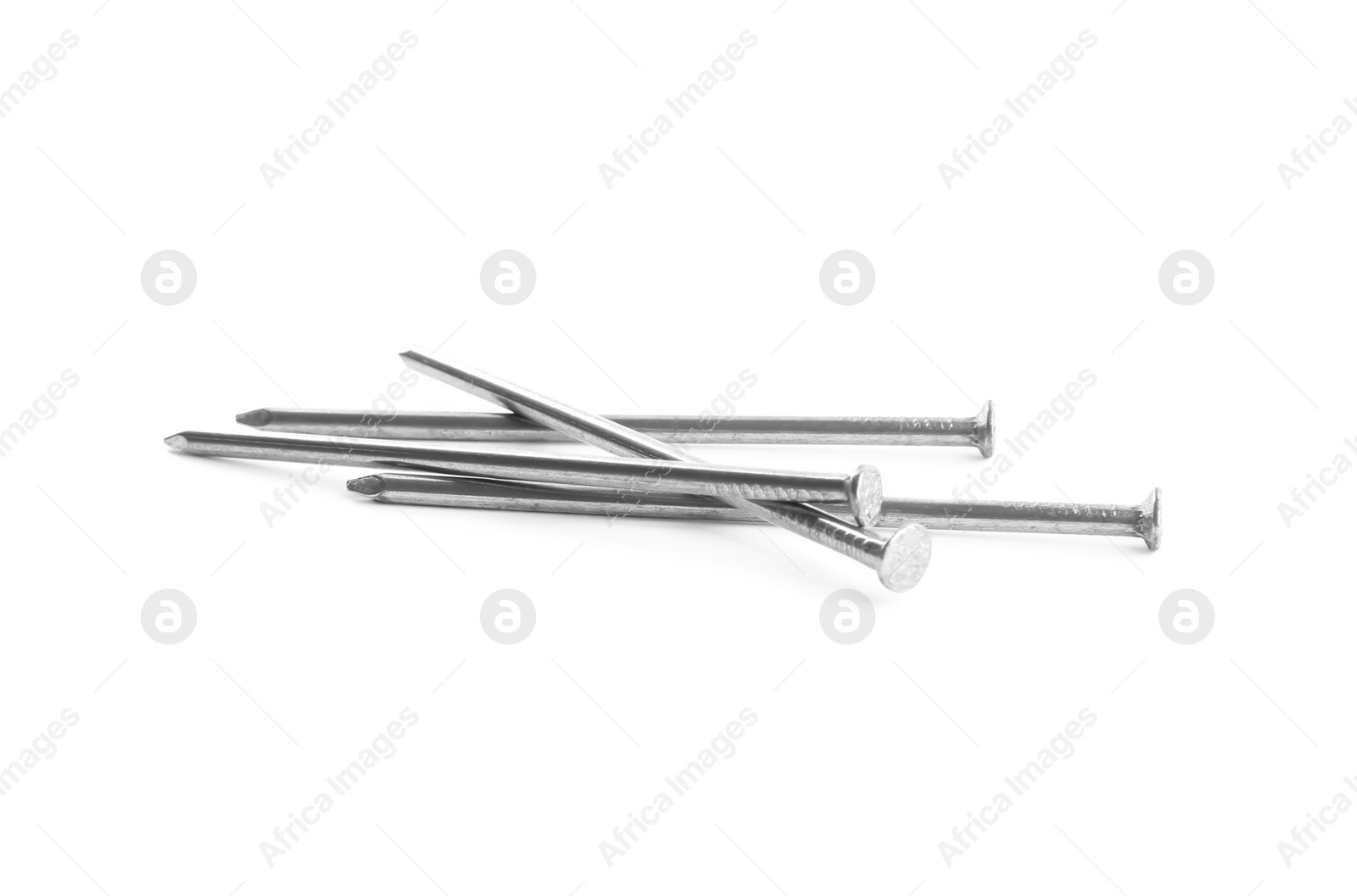 Photo of Sharp shiny metal nails on white background