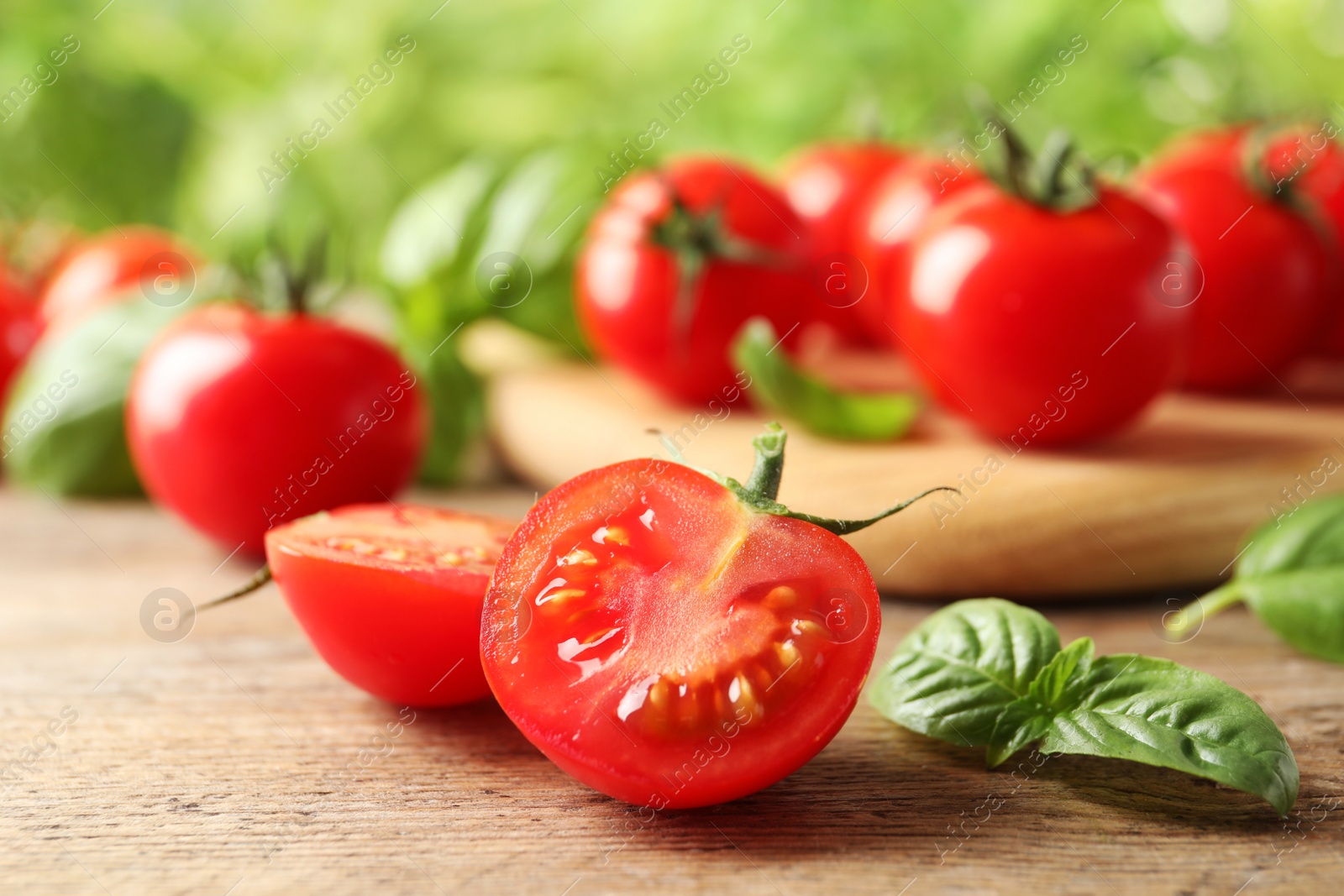 Photo of Fresh organic cherry tomatoes on wooden table