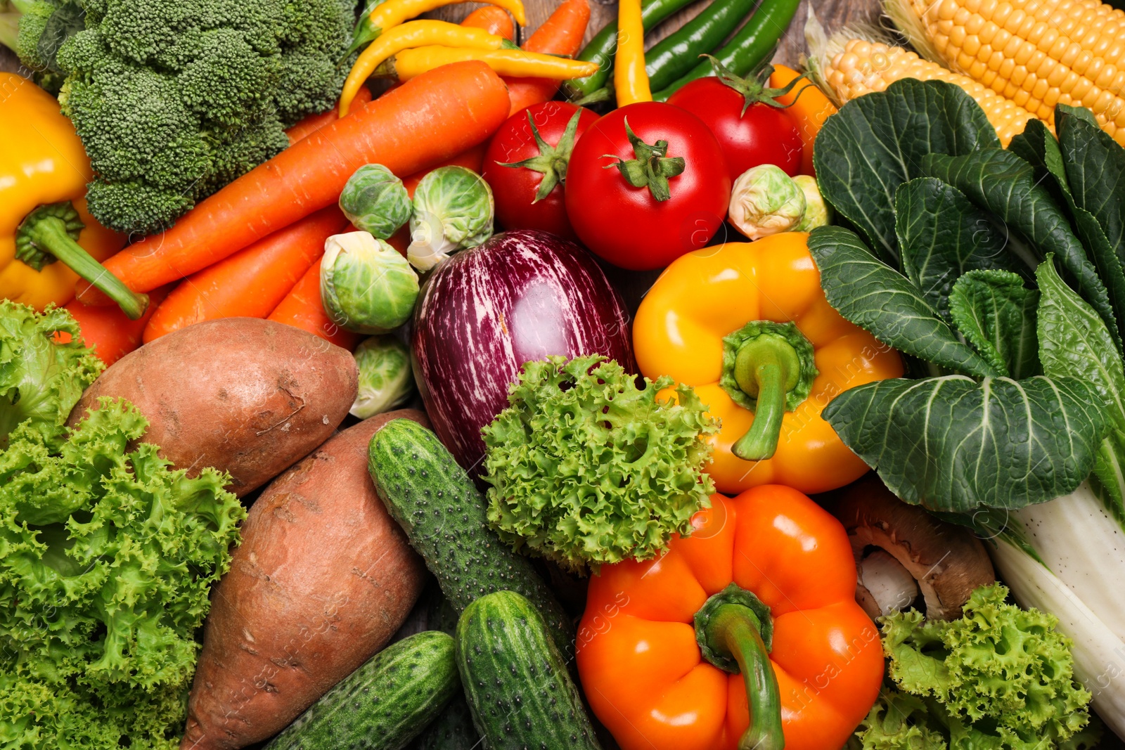 Photo of Different fresh vegetables as background, top view