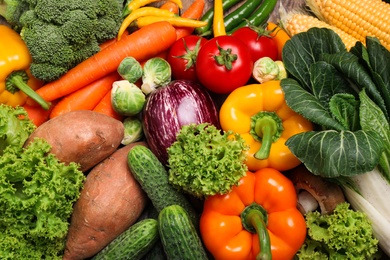 Photo of Different fresh vegetables as background, top view