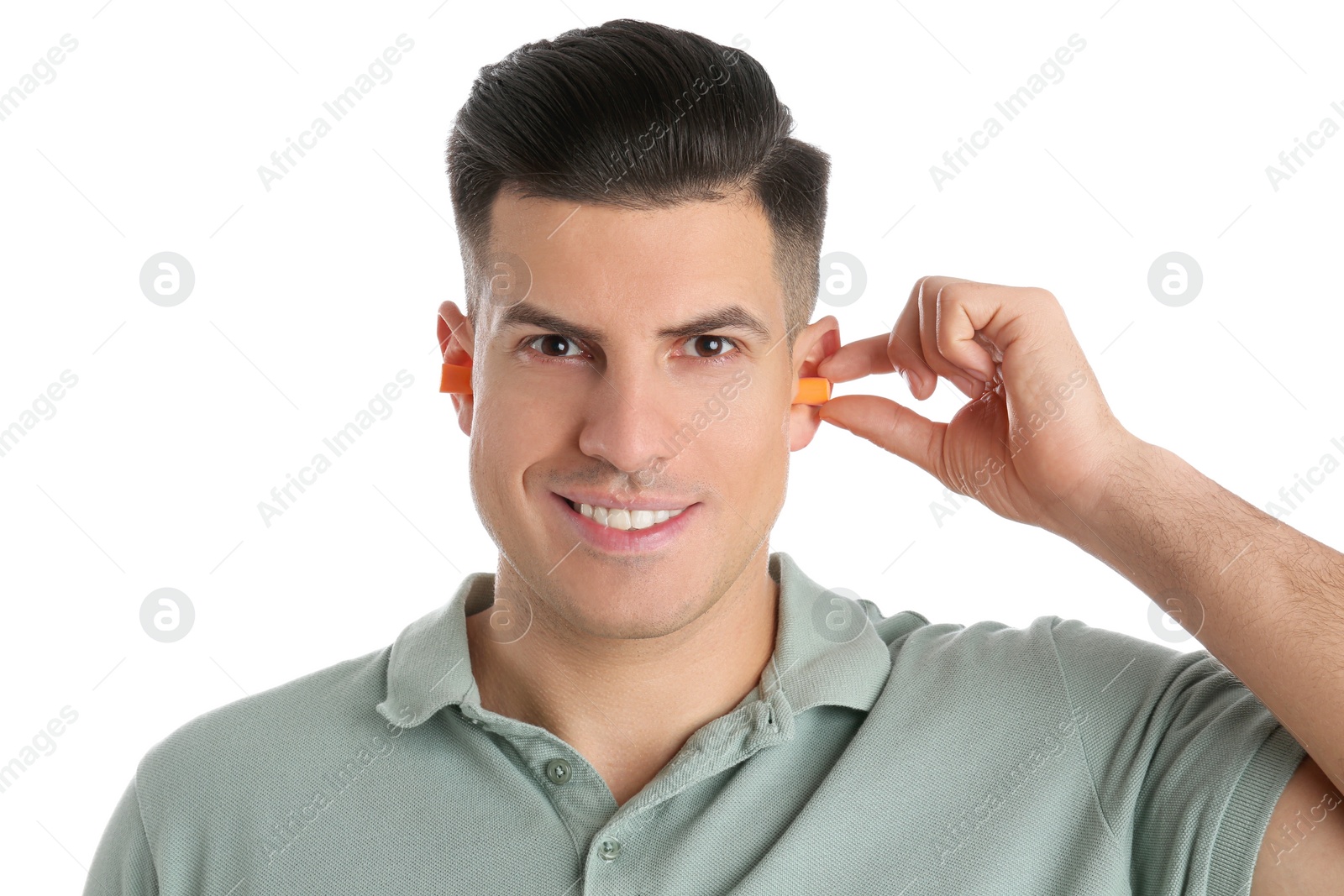 Photo of Man inserting foam ear plug on white background