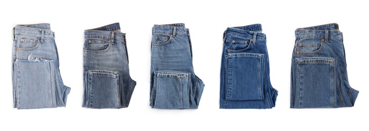 Image of Set with different jeans on white background, top view