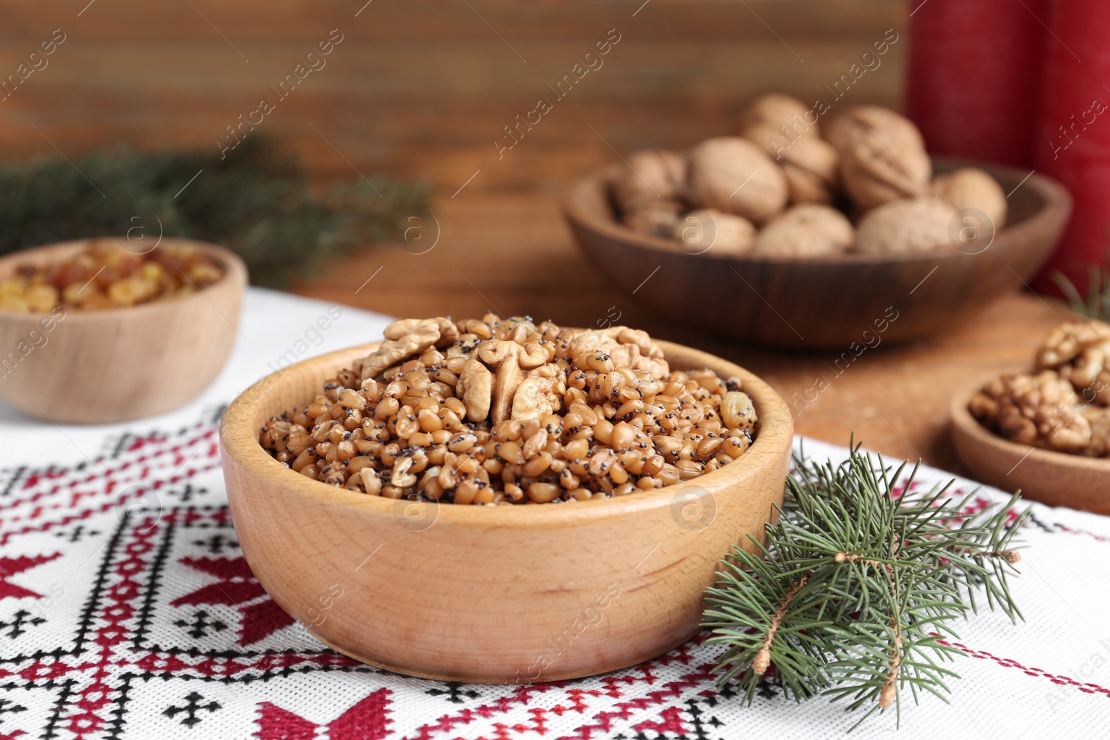 Photo of Traditional Christmas slavic dish kutia in bowl on rushnyk, closeup