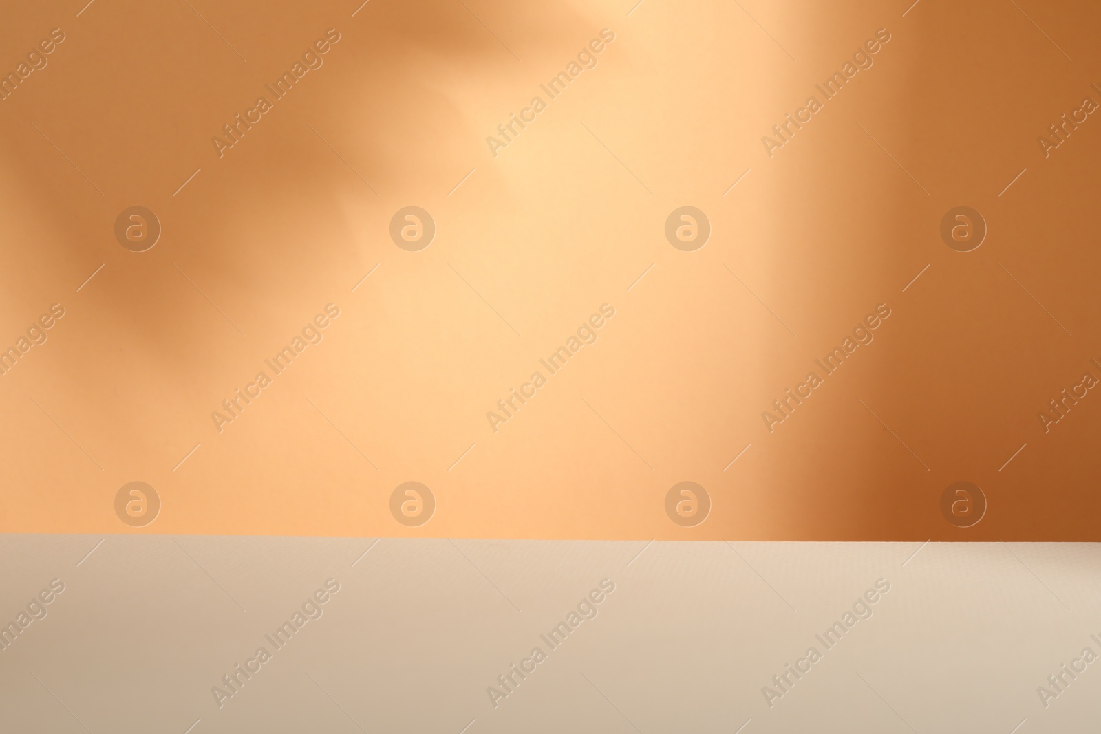 Photo of Presentation of product. Shadows on orange background. Space for text