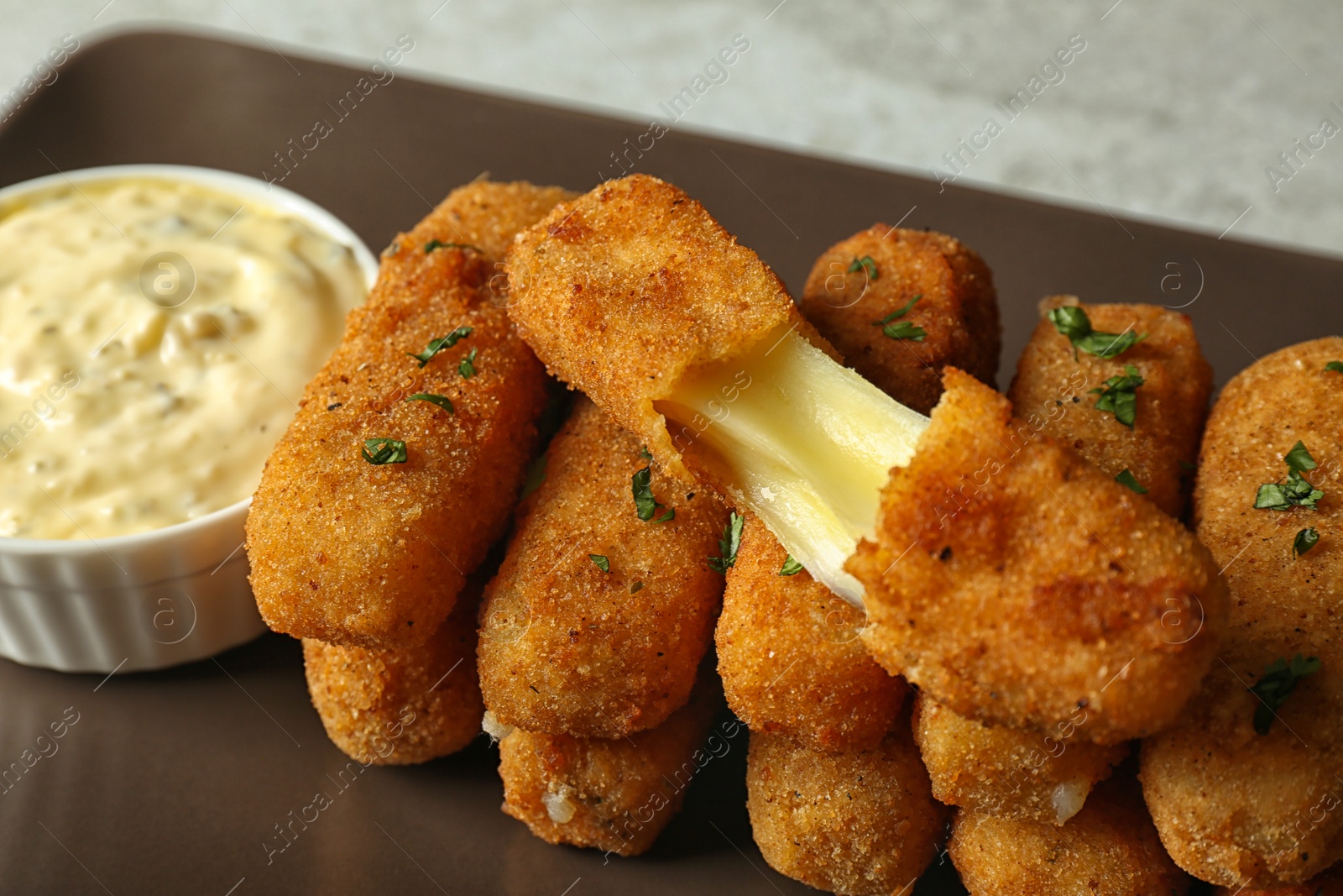 Photo of Plate with cheese sticks and sauce, closeup