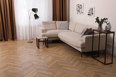 Modern living room with parquet flooring and stylish furniture