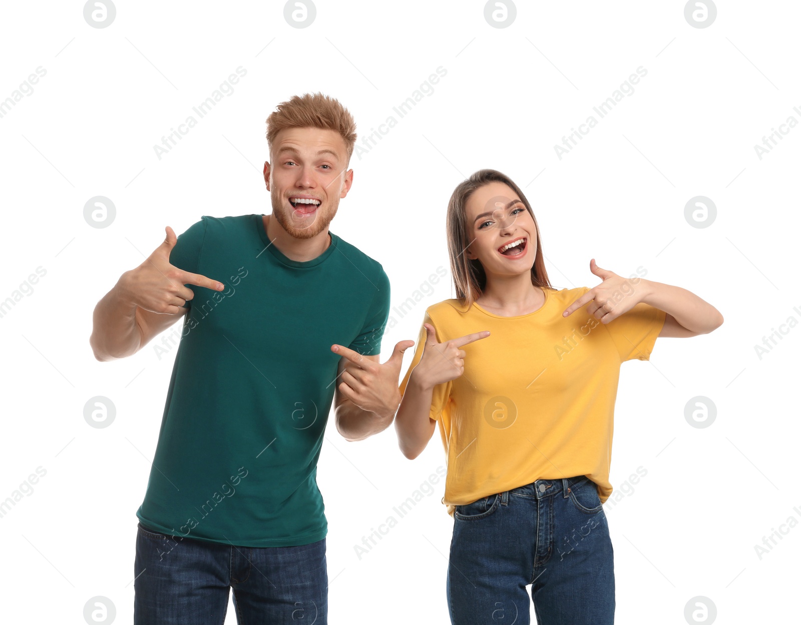 Photo of Young couple wearing blank t-shirts isolated on white. Mockup for design