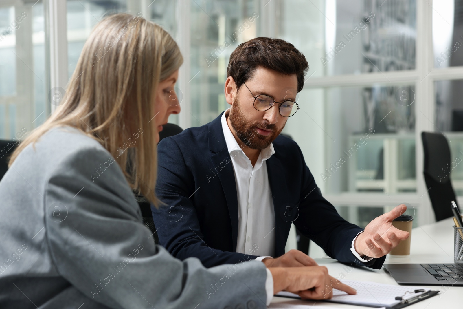 Photo of Lawyers working together at table in office