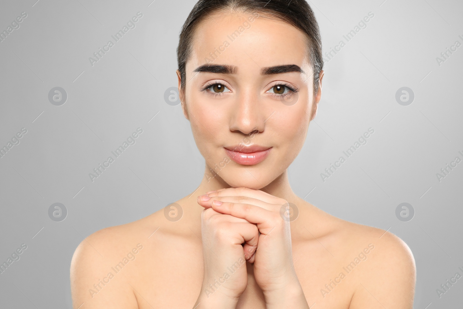 Photo of Portrait of young woman with beautiful face against color background