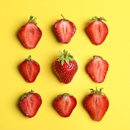 Photo of Tasty ripe strawberries on yellow background, flat lay