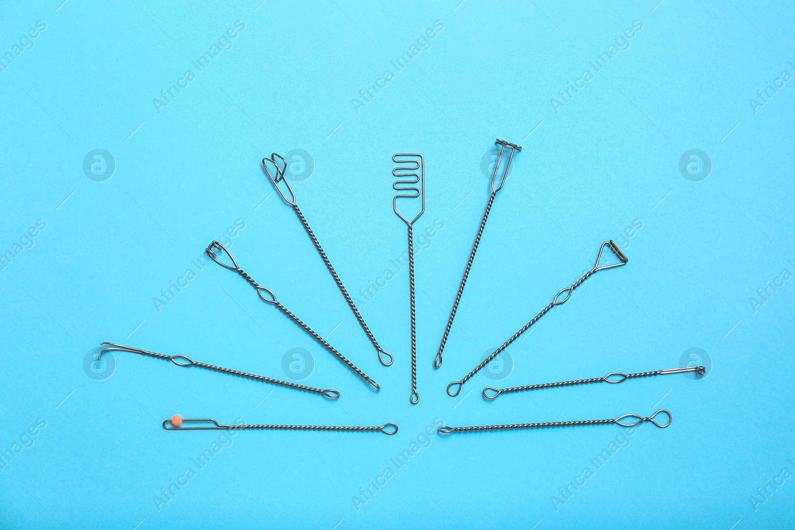 Photo of Set of logopedic probes for speech therapy on light blue background, flat lay