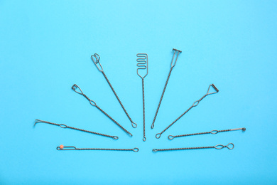 Photo of Set of logopedic probes for speech therapy on light blue background, flat lay