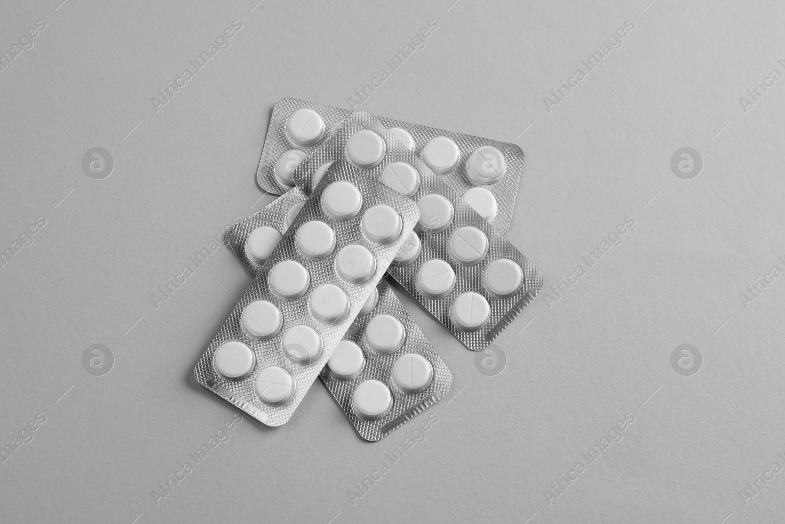 Photo of Blisters of pills on white background, top view