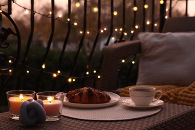 Photo of Beautiful view of garden furniture with pillow, soft blanket and coffee at balcony