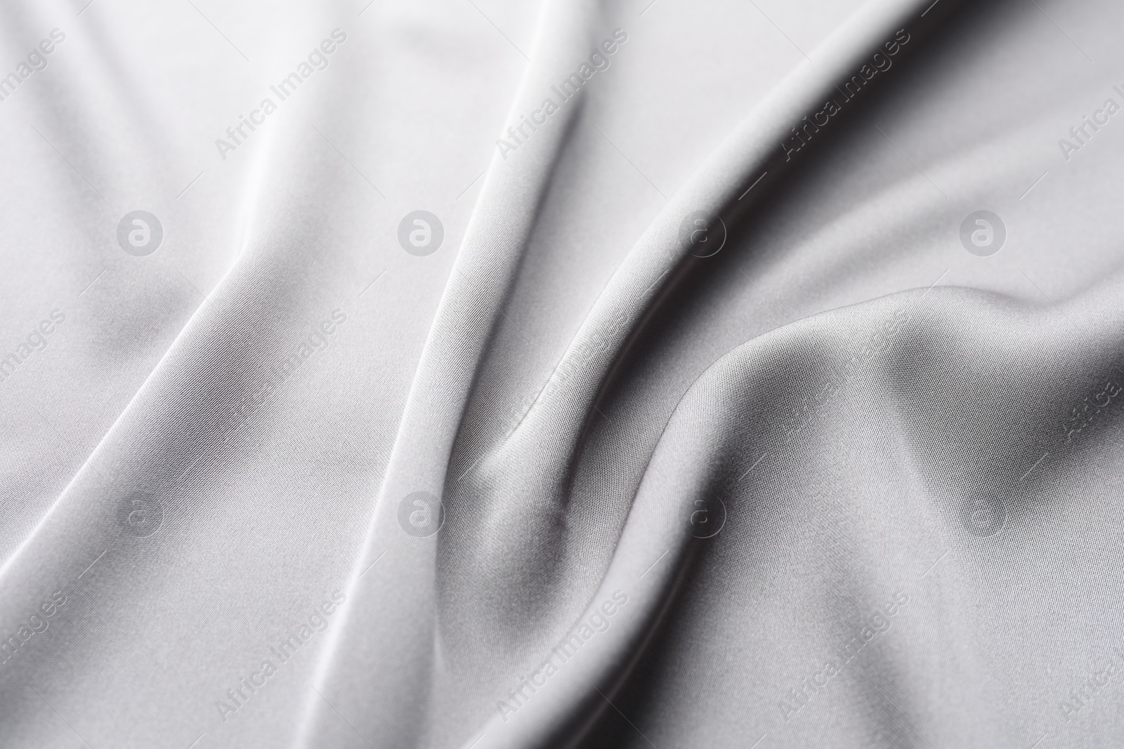 Photo of Texture of beautiful light grey silk fabric as background, closeup