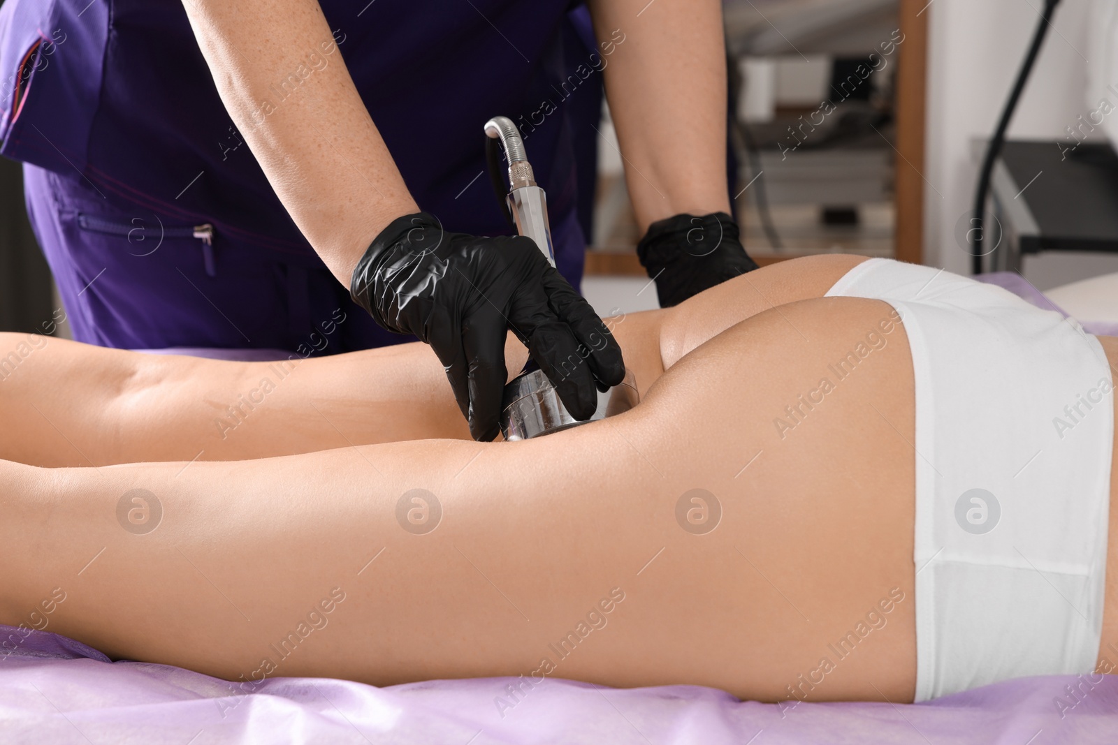 Photo of Woman undergoing radio frequency lifting procedure in beauty salon, closeup