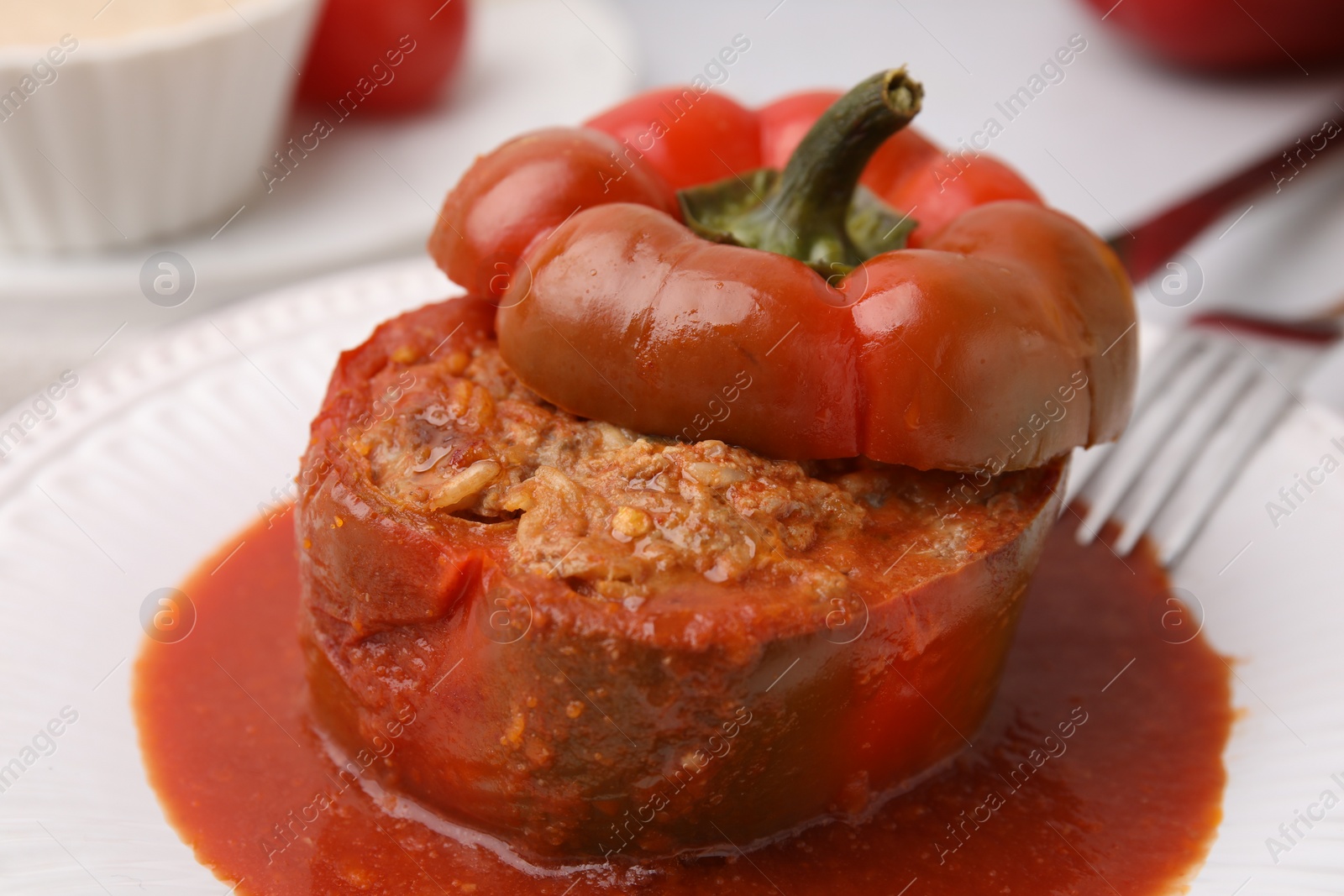 Photo of Delicious stuffed bell pepper served on light table, closeup