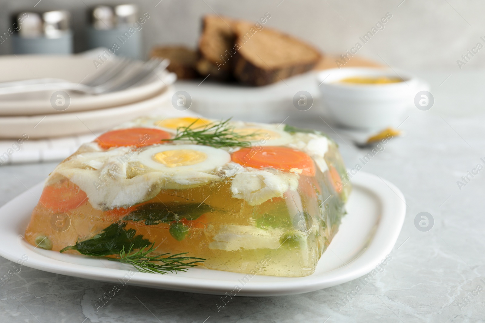 Photo of Delicious fish aspic served on grey marble table