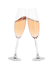 Photo of Toasting with glasses of rose champagne on white background
