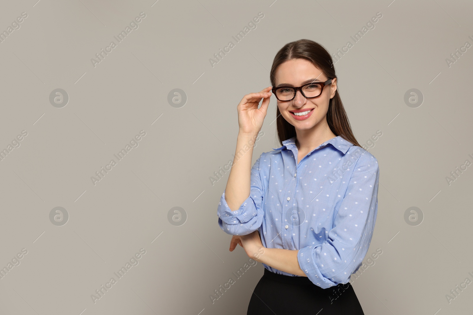 Photo of Portrait of beautiful young teacher on grey background. Space for text