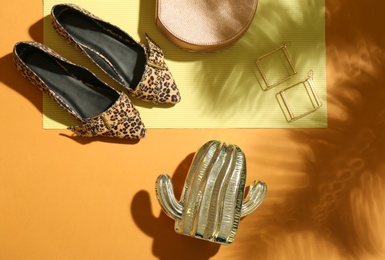 Photo of Flat lay composition with lady's shoes on color background