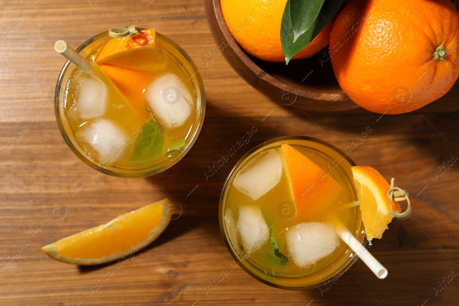 Photo of Delicious orange soda water on wooden table, flat lay