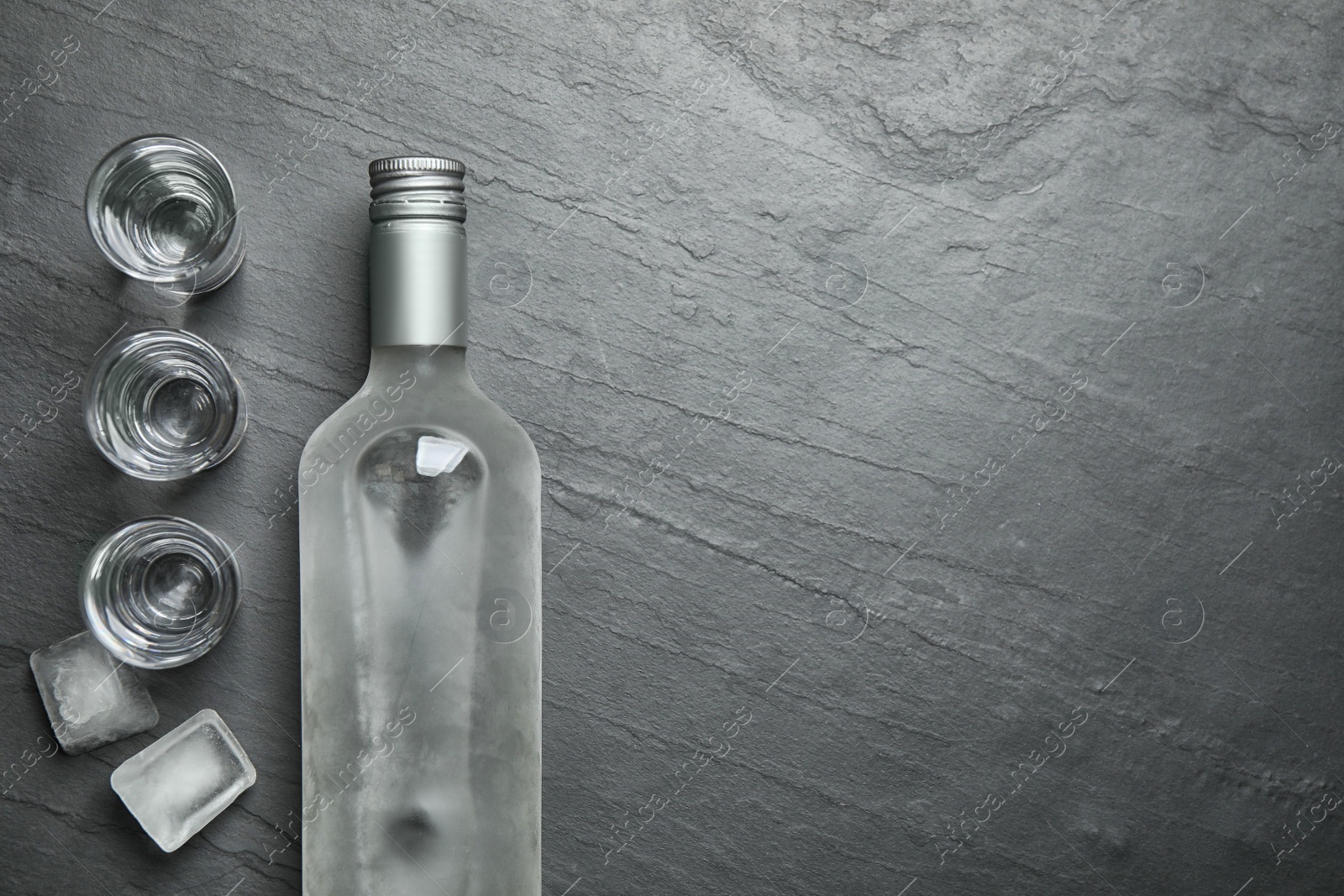 Photo of Cold Russian vodka on black table, flat lay. Space for text