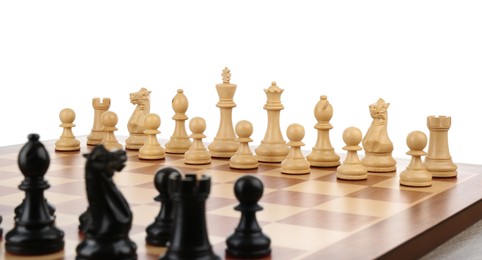 Set of chess pieces on wooden board against white background