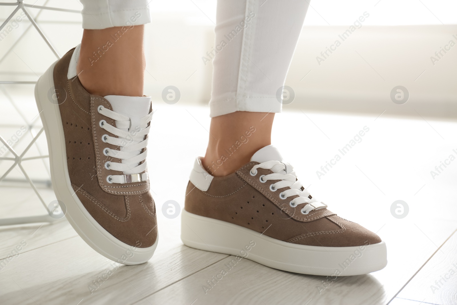 Photo of Woman wearing comfortable stylish shoes indoors, closeup