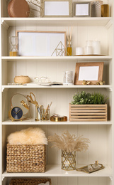 Photo of White shelving unit with different decorative elements