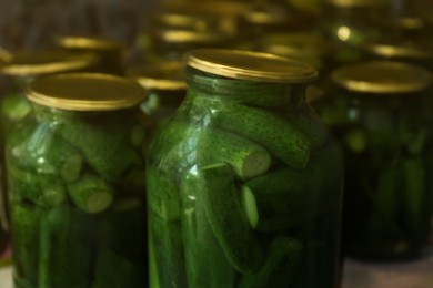 Photo of Glass jars with pickled cucumbers, closeup view