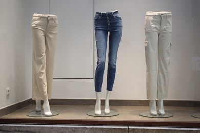 Photo of Shop display with mannequins in stylish pants