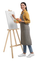 Young woman drawing on easel against white background