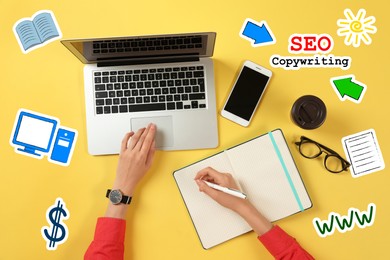 Seo copywriting. Content manager working with laptop and notepad at yellow table, top view. Virtual icons around her