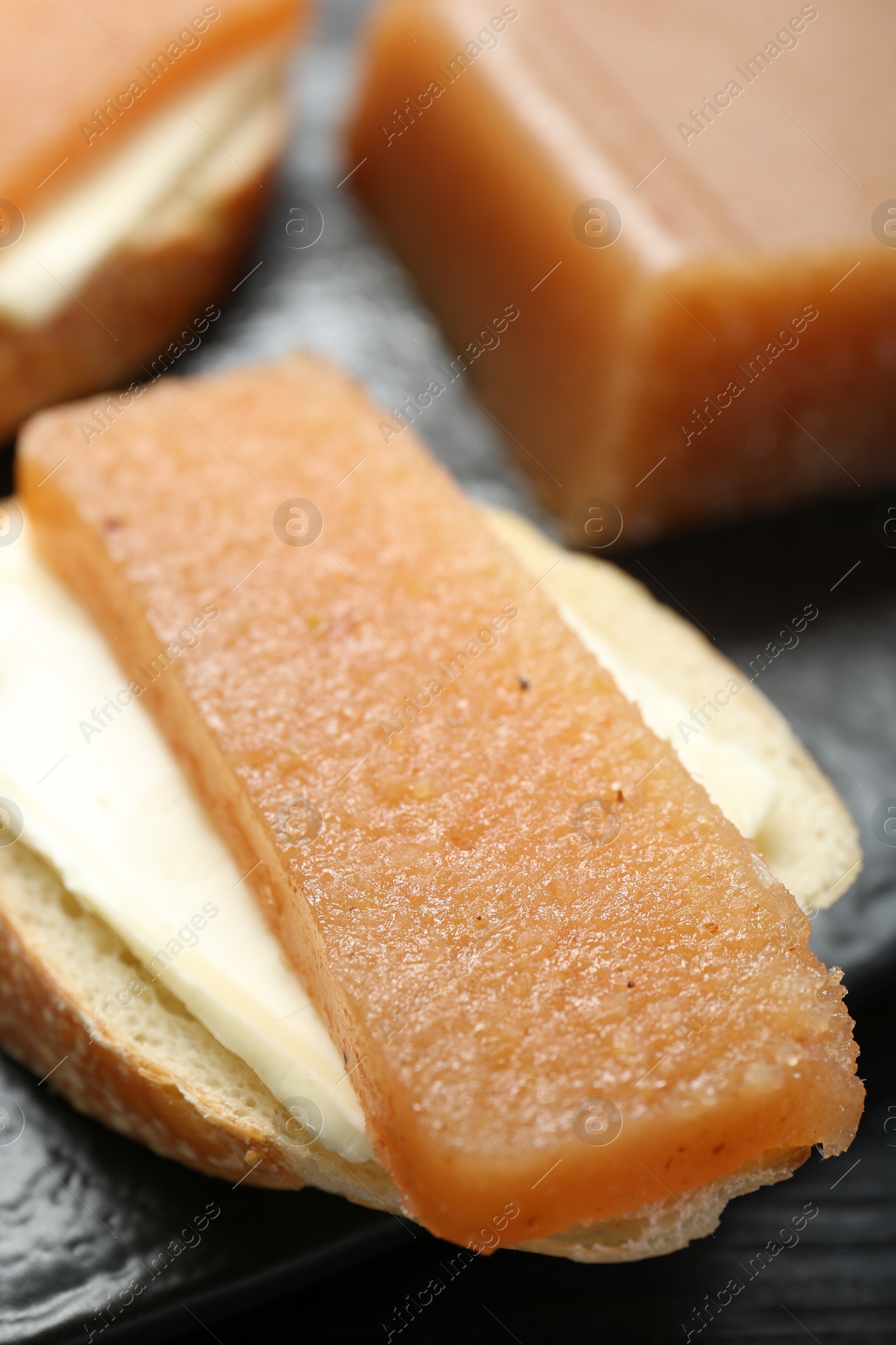 Photo of Tasty sandwich with quince paste on table, closeup