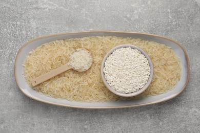 Photo of Different sorts of rice on grey table, top view