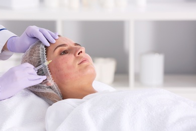 Photo of Woman undergoing face biorevitalization procedure in salon. Cosmetic treatment