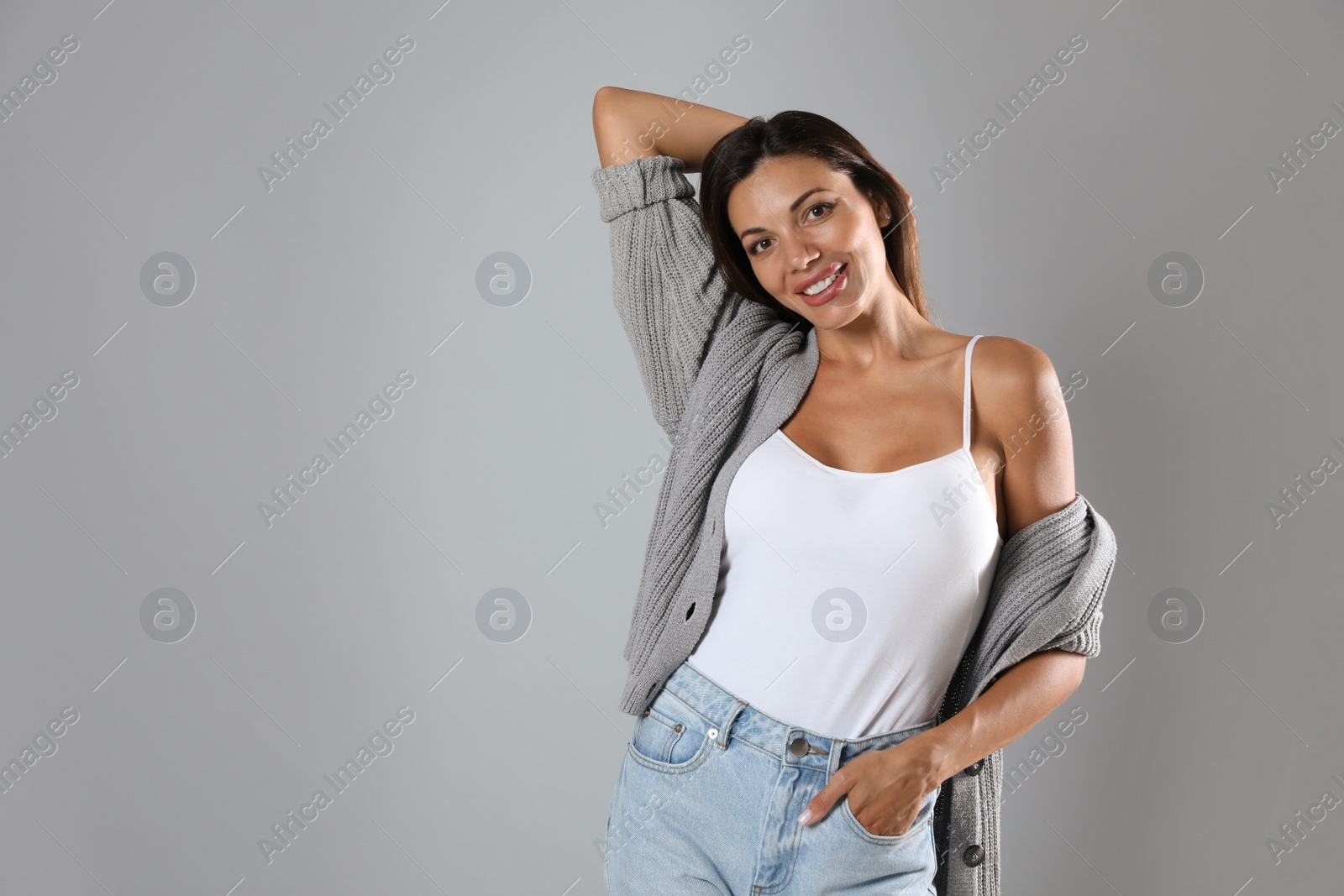 Photo of Portrait of beautiful woman on light grey background, space for text