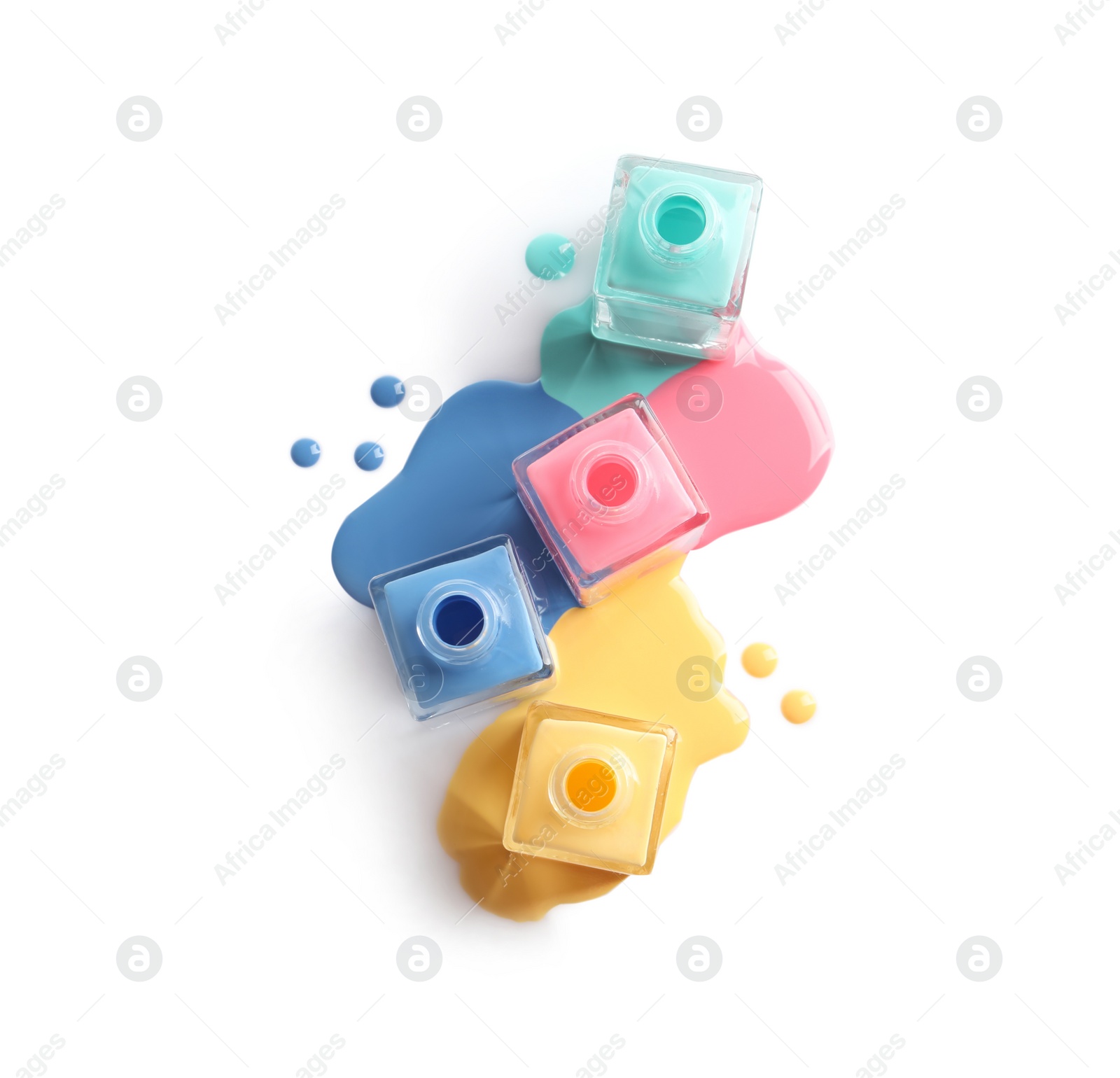 Photo of Spilled different nail polishes with bottles on white background, top view